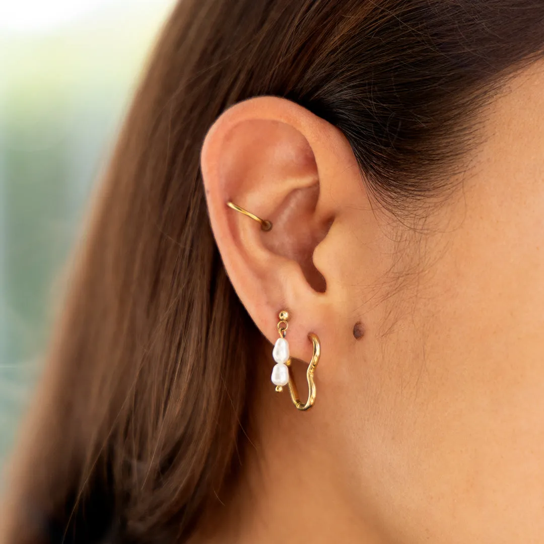 Gold coloured hoop earrings with a heart shape